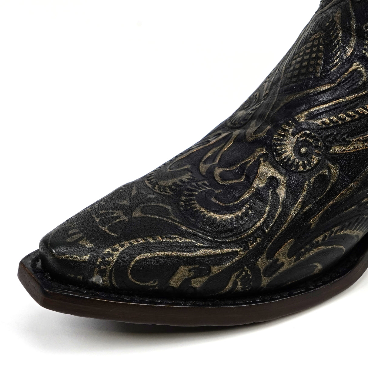 Black cowboy boot with intricate gold embroidery on a white background