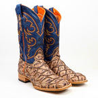 Pair of cowboy boots with blue top section and brown patterned sole on a white background