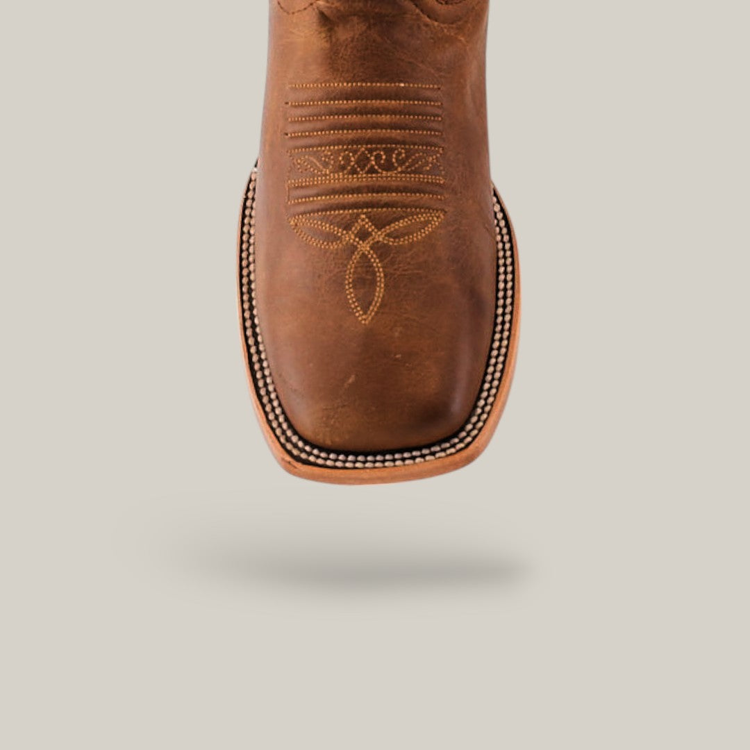 Close-up of a Siberia Honey - Square Toe boot showcasing premium leather, intricate stitching, and a square shape on a light gray background.