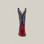 The Exotic Python - Ruby / Blue - Square Toe boot is shown front-facing, with a red textured lower and blue upper shaft featuring white stitching, against a plain beige background. From the Platinum Collection.