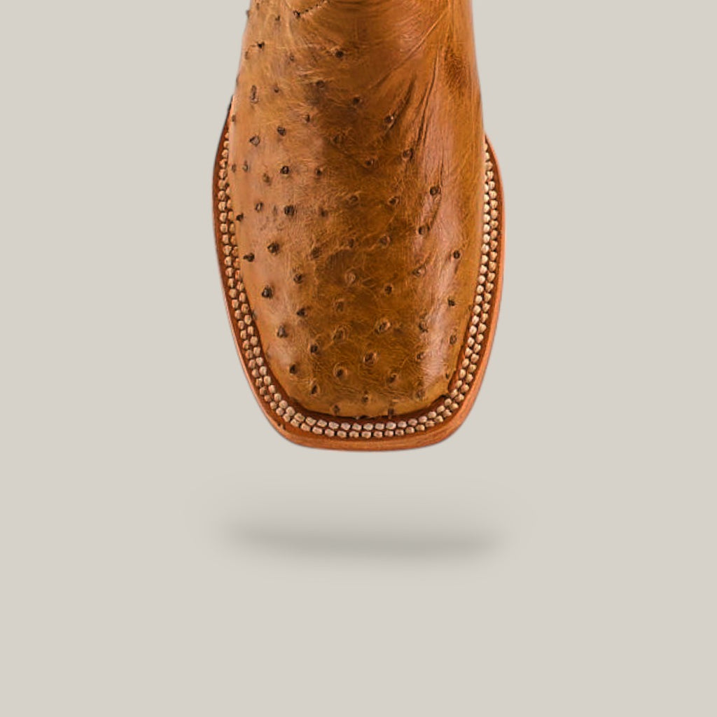 Close-up of Exotic Full Quilt Ostrich Fawn - Square Toe - Kids Boots, crafted from luxurious ostrich leather with a square toe and decorative edge stitching, set against a plain light background for classic Western style.