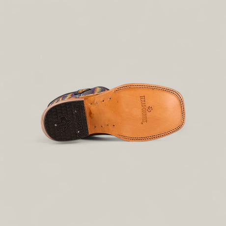 A single Exotic Full Quilt Ostrich Fawn - Square Toe - Kids Boot is shown from the bottom, featuring Western elegance with a tan leather sole, LUCCHESE and star logo, black heel, and visible stitching.