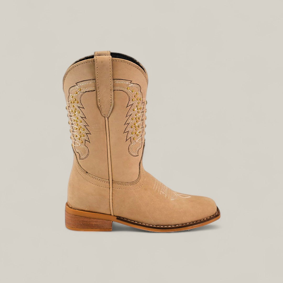 The Orion Suede Bone - Square Toe - Kids Boots feature tan suede, decorative stitching, light brown accents, a short stacked heel, pull straps on each side, and a square toe silhouette, shown on a neutral background.