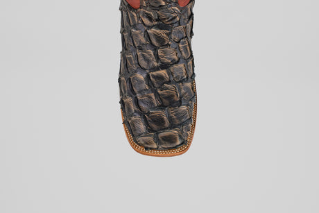 Close-up of the toe of the Butch - Caramel - Square Toe cowboy boot featuring decorative stitching and a textured pattern, crafted from luxurious Pirarucu leather for an exotic look.