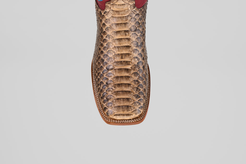 A close-up, top view of the Barlow - Taupe - Square Toe boot highlights its python leather texture, detailed scale patterns, and visible stitching—an eye-catching choice for mens statement footwear.