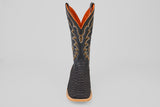 The Wayne - Matte Black - Square Toe boot features a matte black, scaly texture, yellow stitching, and a brown sole. Shown from the front on a plain light gray background.