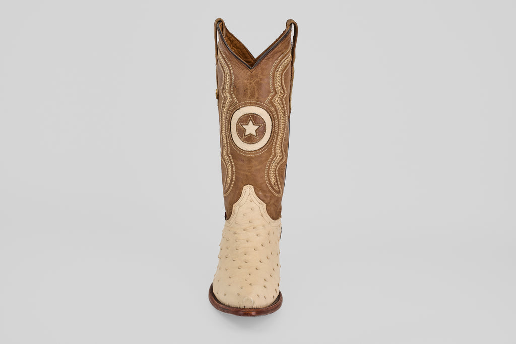 The Austin - Bone - Snip Toe cowboy boot features a tan ostrich leather foot, brown upper with decorative stitching, and a circular star patch, shown against a plain white background.