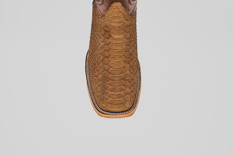 Top view of the Tanner - Tamarindo - Square Toe cowboy boot in brown Python Tamarindo leather featuring a textured snakeskin pattern and decorative stitching around the sole, displayed on a plain white background.