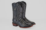 The Tanner - Black - Round Toe boots feature black leather with intricate shaft stitching, textured Python Negro Oval-patterned feet, brown wooden heels, and a decorative metal emblem on the side.