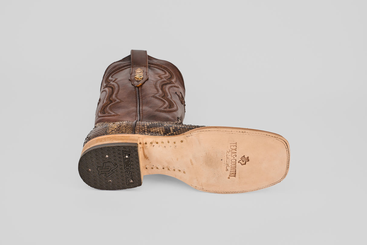A single Tanner – Dune – Square Toe cowboy boot shown from the side and bottom, featuring a brown leather upper with decorative stitching, a textured lower section, and the TEXAS COUNTRY logo on the sole.