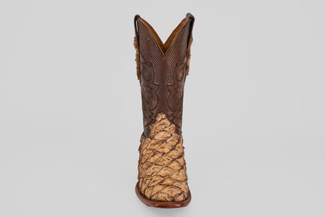 The Conor - Matte Orix - Narrow Square Toe features a single cowboy boot with textured tan Pirarucu leather in a matte finish and a dark brown, intricately stitched upper, shown on a plain light gray background.