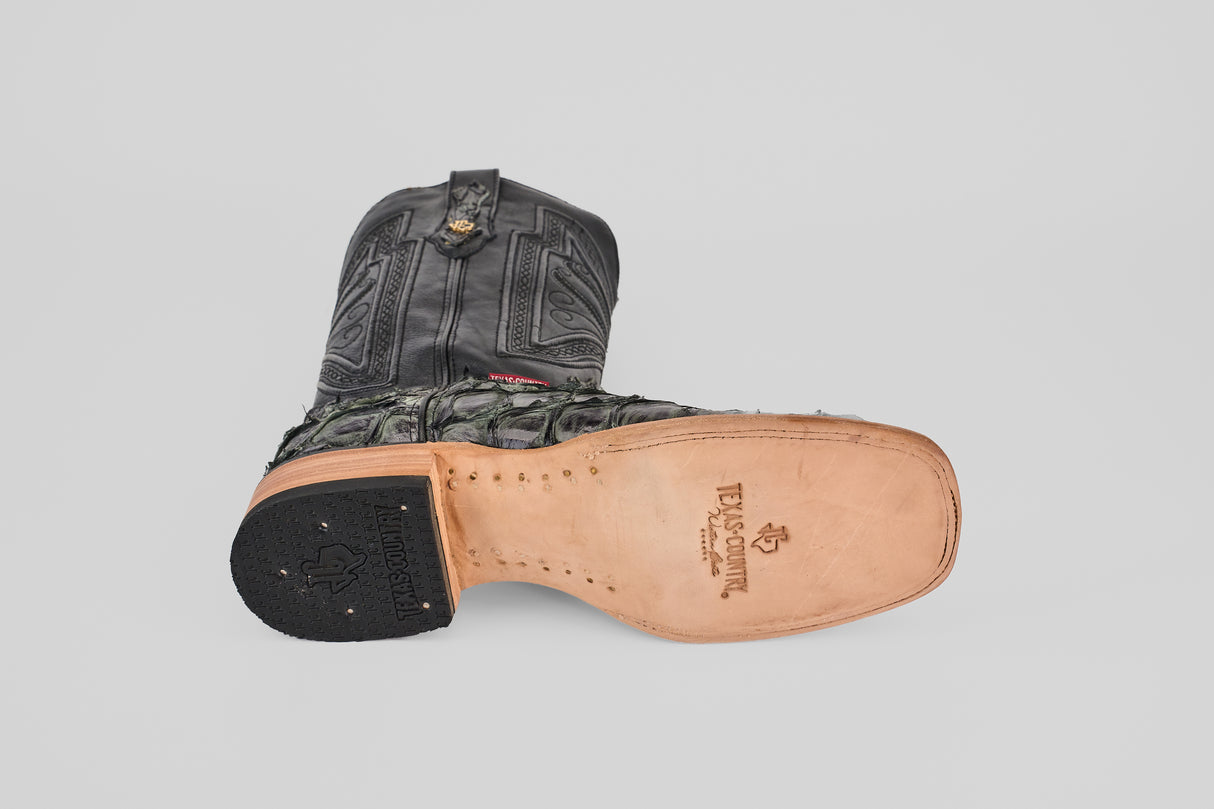 The Conor - Charcoal - Square Toe cowboy boot features an intricate black and green upper, a tan leather sole stamped with TEJAS SCOUT branding, and a premium square toe—ideal for style-conscious men.