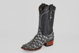 The Conor - Newspaper boot features a black, narrow square toe with a scale-like lower pattern reminiscent of fish leather, a smooth leather upper, pull straps, and a brown wooden heel, all showcased on a white background.