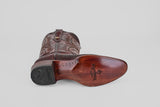The Ranger – Wine – Round Toe men’s cowboy boot is shown on its side, featuring a smooth wooden sole with branding and a black heel, adding Western style against a plain light gray background.