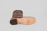 The Blaze – Brown – Square Toe Cowboy Boot is shown on its side, revealing a tan leather sole with branding, a partially black heel with logo imprint, and classic western-style decorative stitching.