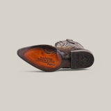 The image highlights the underside of the Flame Grey Ostrich Laser & Embroidery Snip Toe Boot (CU810), featuring intricate laser-engraved patterns on a reddish-brown leather sole marked Cuadra Tradicional, set against a neutral light gray background.