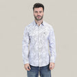 A man with short dark hair and a beard wears the Mens Western Modern Fit Cotton/Spandex Long Sleeve White Shirt with Snaps (WPL10822) and blue jeans, standing against a plain light beige background.